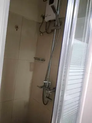 a shower in a bathroom next to a window at 257 moa view with balcony bigcut in Manila
