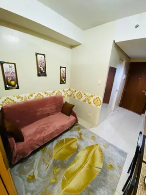 a living room with a couch in the corner of a room at triple-D in Manila