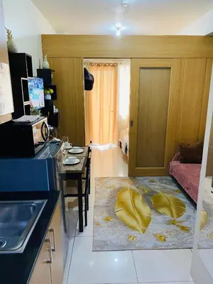 a kitchen with a living room with a table and a room with a kitchen at triple-D in Manila