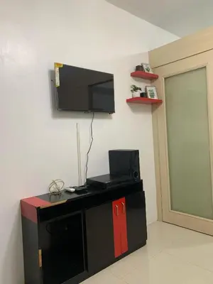 a room with a flat screen tv on a wall at Sea Residence in Manila