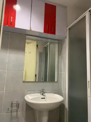 a bathroom with a sink and a mirror at Sea Residence in Manila