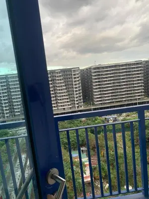 a view of a city from a balcony with buildings at Ballentos staycation in Manila