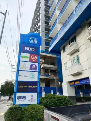 a sign in front of a tall building at Ballentos staycation in Manila