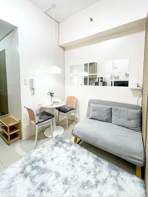 a living room with a couch and a table at Rosemary Shore 2 Residences 1BR in Manila