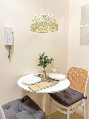 a white table with a vase of flowers on it at Rosemary Shore 2 Residences 1BR in Manila