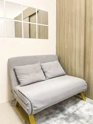 a bed sitting in a room with a mirror at Rosemary Shore 2 Residences 1BR in Manila