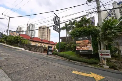 an empty street with a sign on the side of the road at Victoria Court Suites - Pasig in Manila