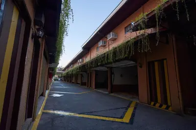 an empty street in an alley between two buildings at Victoria Court Las Pinas in Manila