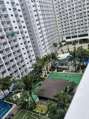 an aerial view of a tennis court in front of tall buildings at AJ Staycation at Shore 1 Residences Tower D in Manila