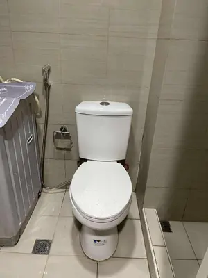a bathroom with a white toilet in a room at AJ Staycation at Shore 1 Residences Tower D in Manila