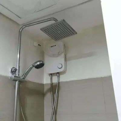 a shower in a bathroom with a shower head at AJ Staycation at Shore 1 Residences Tower D in Manila