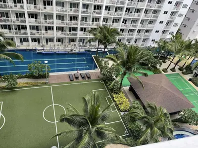 an aerial view of a tennis court in front of a building at AJ Staycation at Shore 1 Residences Tower D in Manila
