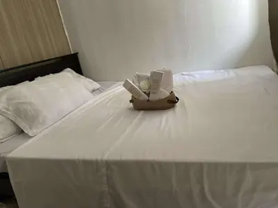 a box of tissues sitting on top of a bed at AJ Staycation at Shore 1 Residences Tower D in Manila