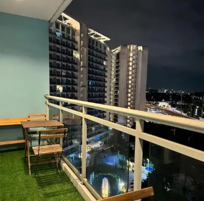 a balcony with a table and chairs on a building at Casa Rhea in Manila