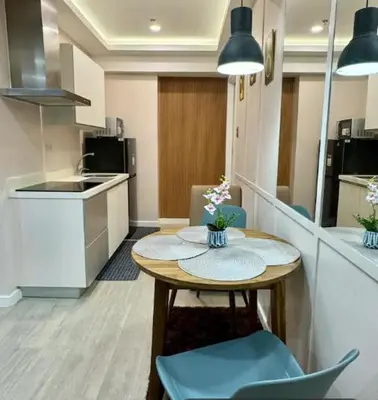 a kitchen with a table and chairs in a room at Casa Rhea in Manila