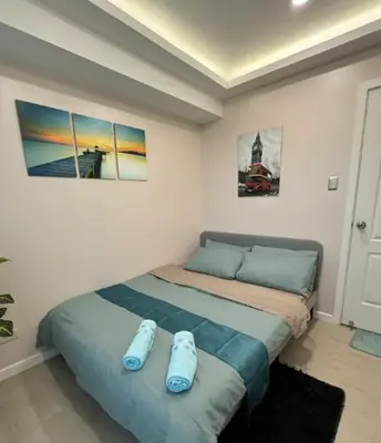 a bedroom with a bed with two shoes on it at Casa Rhea in Manila