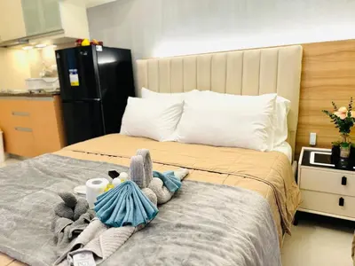 a bedroom with a bed with stuffed animals on it at Staycation near Venice Mall mckinley taguig in Manila
