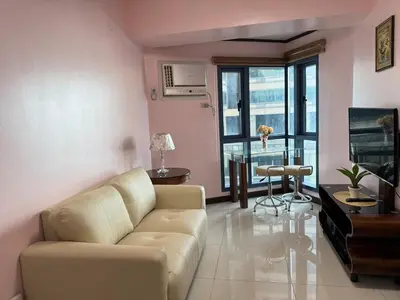 a living room with a couch and a table at Grand Riviera Suites 1201 Near US Embassy and St Luke's Medical Center Extension Clinic SLEC by Prime Stay in Manila