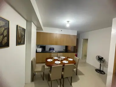 a kitchen and dining room with a table and chairs at Moa view with big balcony 558 in Manila