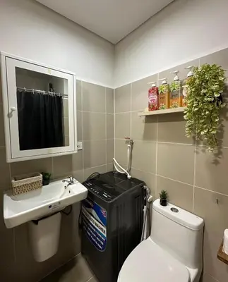 a small bathroom with a toilet and a sink at Casa Alia at Coast - near MOA, US Embassy, PICC, WTC in Manila