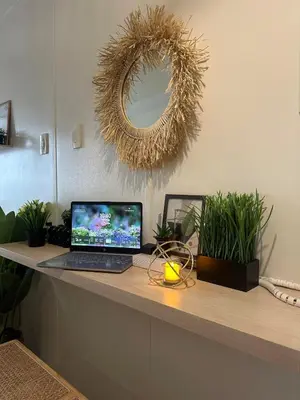 a laptop computer sitting on a counter with plants at Casa Alia at Coast - near MOA, US Embassy, PICC, WTC in Manila