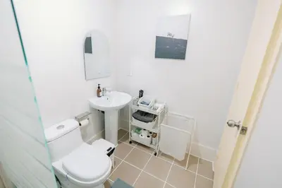 a bathroom with a toilet and a sink at Cozy 2-Bedroom at South of Market SOMA BGC near SM Aura, Market! Market! & Bonifacio High Street in Manila