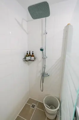 a bathroom with a shower with a toilet in it at Cozy 2-Bedroom at South of Market SOMA BGC near SM Aura, Market! Market! & Bonifacio High Street in Manila