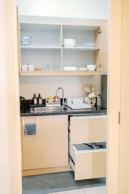 a small kitchen with a sink and a counter at Cozy 2-Bedroom at South of Market SOMA BGC near SM Aura, Market! Market! & Bonifacio High Street in Manila