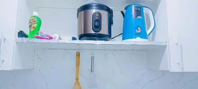 a shelf with a blender and other items on it at Avida sm sucat quest house condo hotel in Manila