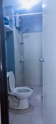 a bathroom with a toilet and a shower stall at Avida sm sucat quest house condo hotel in Manila