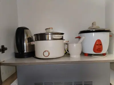 a counter with two crock pots and a toaster at Coast Residence Sea View Balcony WiFi Netflix Near MOA 1524 in Manila