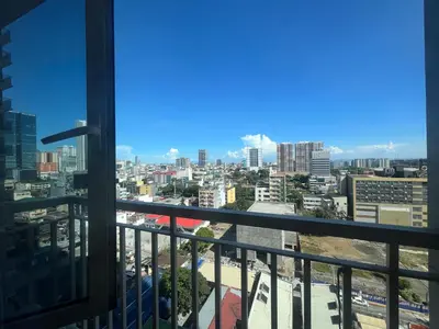 a view of a city from a building balcony at Coast Residence Sea View Balcony WiFi Netflix Near MOA 1524 in Manila