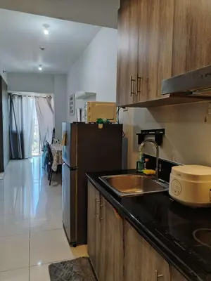 a kitchen with a sink and a refrigerator at Coast Residence Sea View Balcony WiFi Netflix Near MOA 1524 in Manila