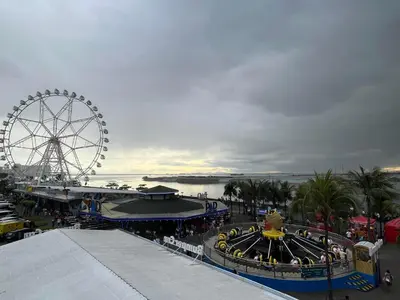 a ferris wheel and a roller coaster at a carnival at Coast Residence Sea View Balcony WiFi Netflix Near MOA 1524 in Manila