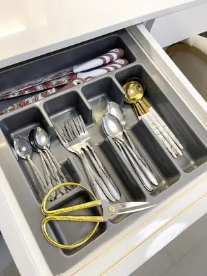 a drawer filled with silver utensils in a cabinet at Luxury Condotel near MOA, NAIA in Manila
