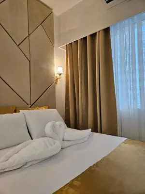 a bed with a towel on it with a window at Luxury Condotel near MOA, NAIA in Manila
