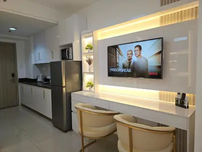 a kitchen with a flat screen tv on a wall at Luxury Condotel near MOA, NAIA in Manila
