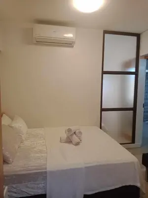 a bedroom with a bed with a stuffed animal on it at 1633 pool view 2br in Manila