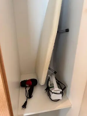 a room with a curtain and a phone on a shelf at BGC One Uptown Premium 2BR Suite with Balcony near Supermarket, Malls and Restaurants in Manila