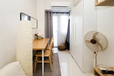 a small apartment with a dining room table and a fan at Charlie's Staycation at Coast Residences in Manila
