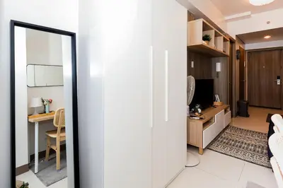 a door leading into a room with a desk at Charlie's Staycation at Coast Residences in Manila