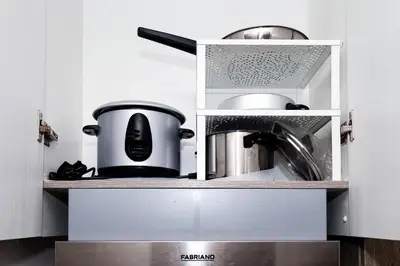 a kitchen with a cooker and pots and pans at Charlie's Staycation at Coast Residences in Manila