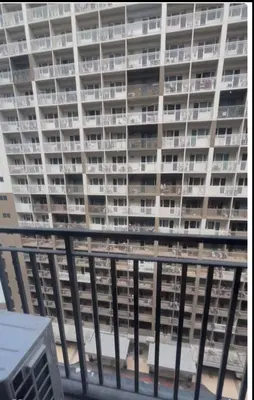 a large apartment building is seen from a balcony at Shore 3 Tower 3 1BD - MOA Complex in Manila