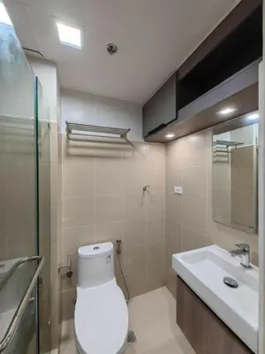 a bathroom with a toilet and a sink at Shore 3 Tower 3 1BD - MOA Complex in Manila
