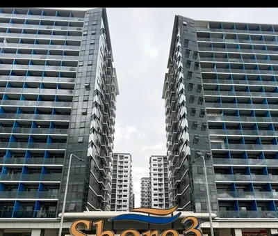 two tall buildings in a city with a sign in front at Shore 3 Tower 3 1BD - MOA Complex in Manila