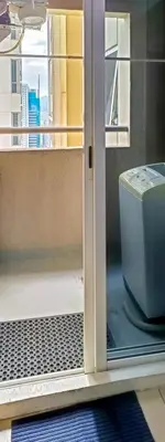 an open door to a toilet on a balcony at Charming Modern Condo in BGC in Manila