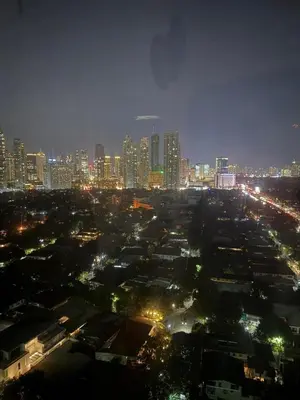 a view of a city at night with lights at Staycation with city lights in Manila