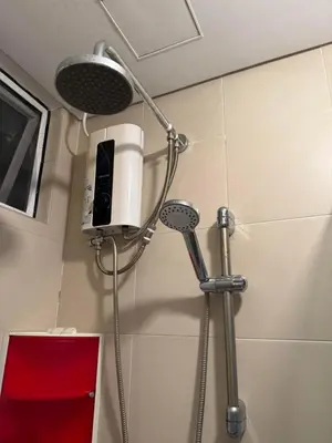 a shower in a bathroom with a phone on the wall at Staycation with city lights in Manila