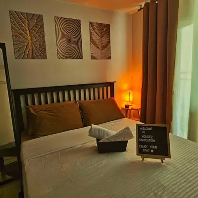 a bedroom with a bed with a sign on it at Azure Urban Resort Staycation in Manila