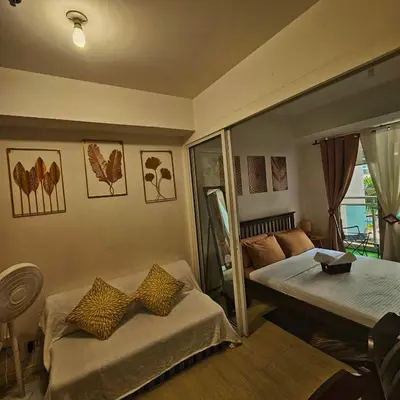 a room with two beds and a table in it at Azure Urban Resort Staycation in Manila